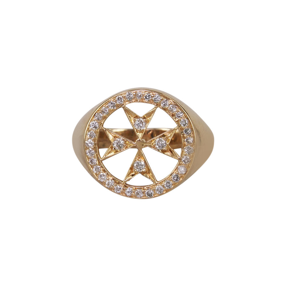 A 14k yellow gold pinky ring with a pave diamond Maltese emblem in the center.