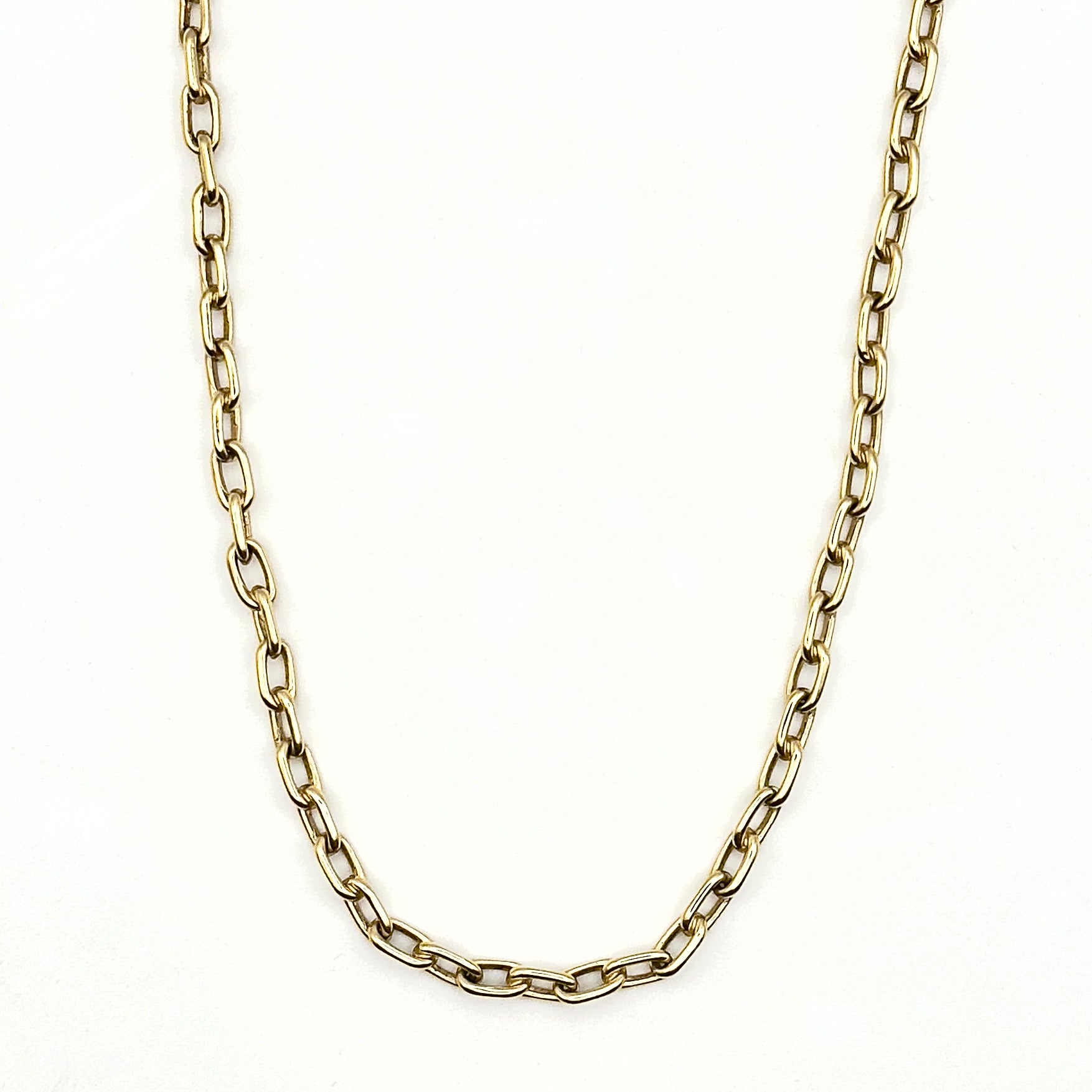 Gold chain necklace on a white background