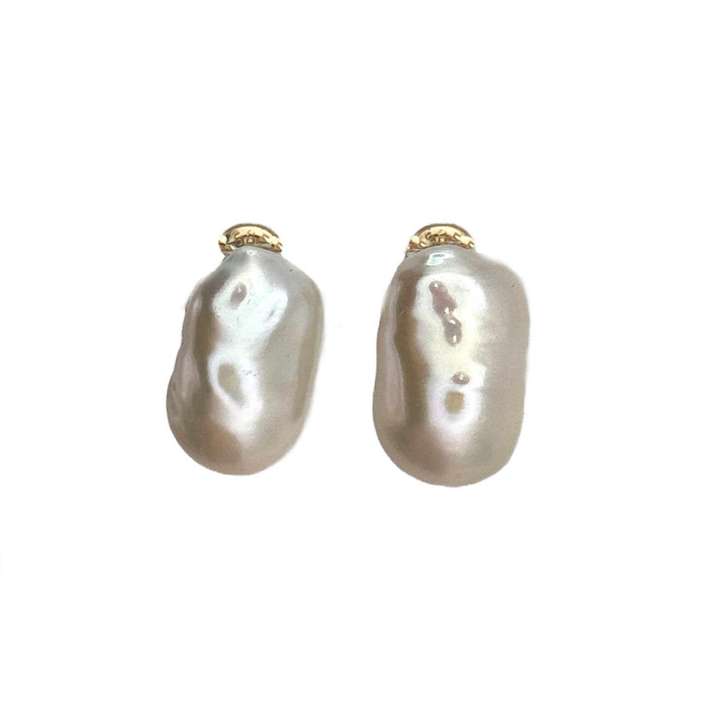 Pair of pearl earrings on a clear stand against a light gray background