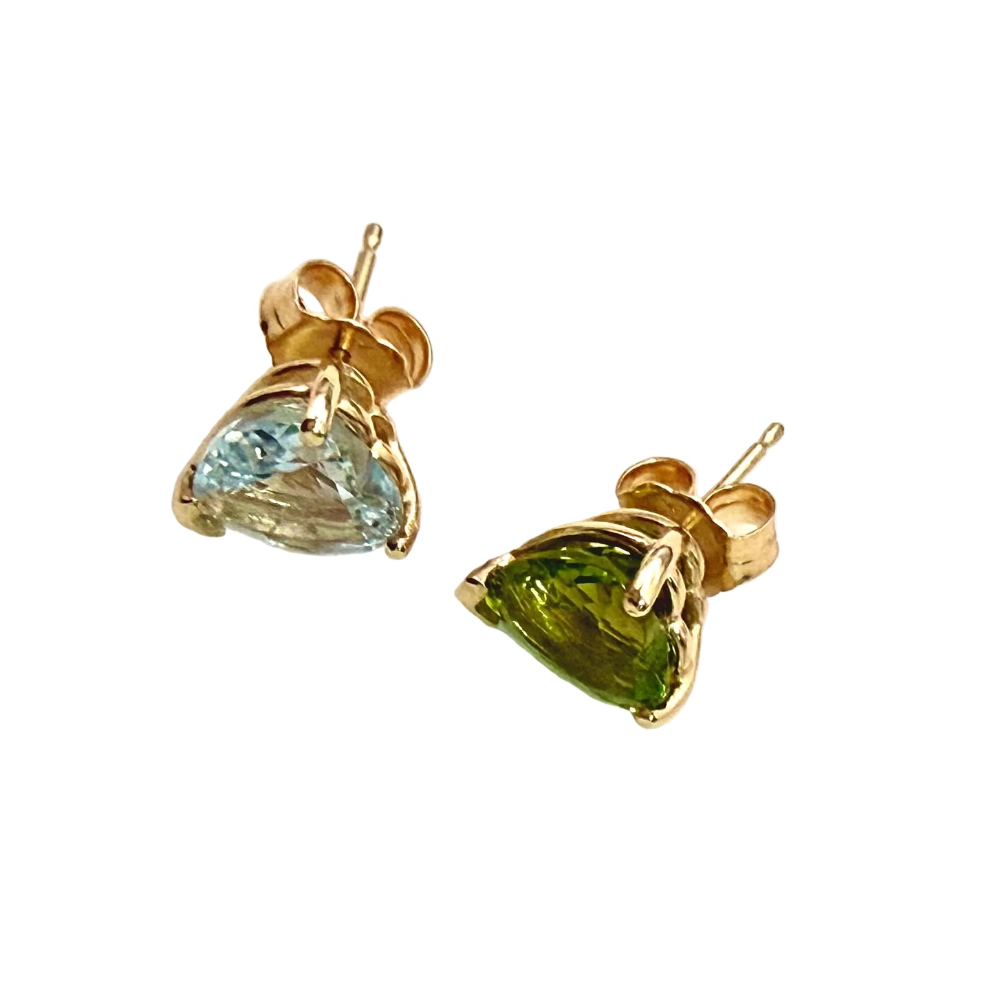 Pair of gold earrings with heart-shaped gemstones on a white background