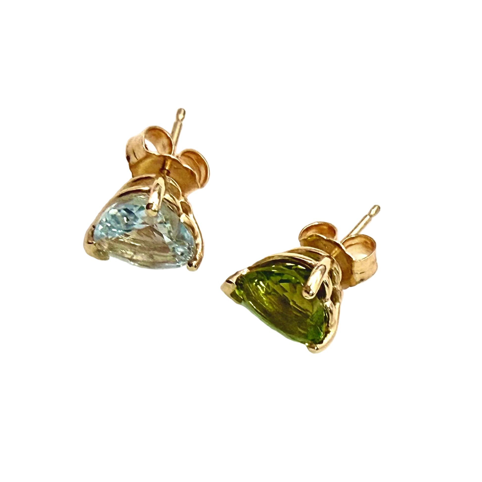Pair of gold earrings with heart-shaped gemstones on a white background