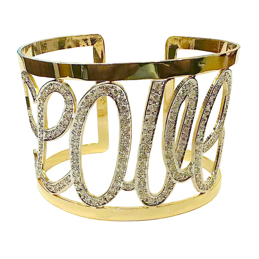 Gold bracelet with 'love' text and gemstones on a white background