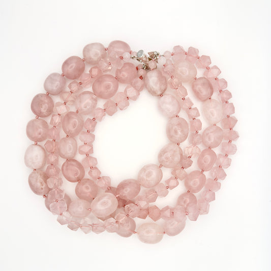 Pink beaded necklace on a white background