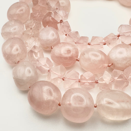 Close-up of a necklace with pink beads on a white background