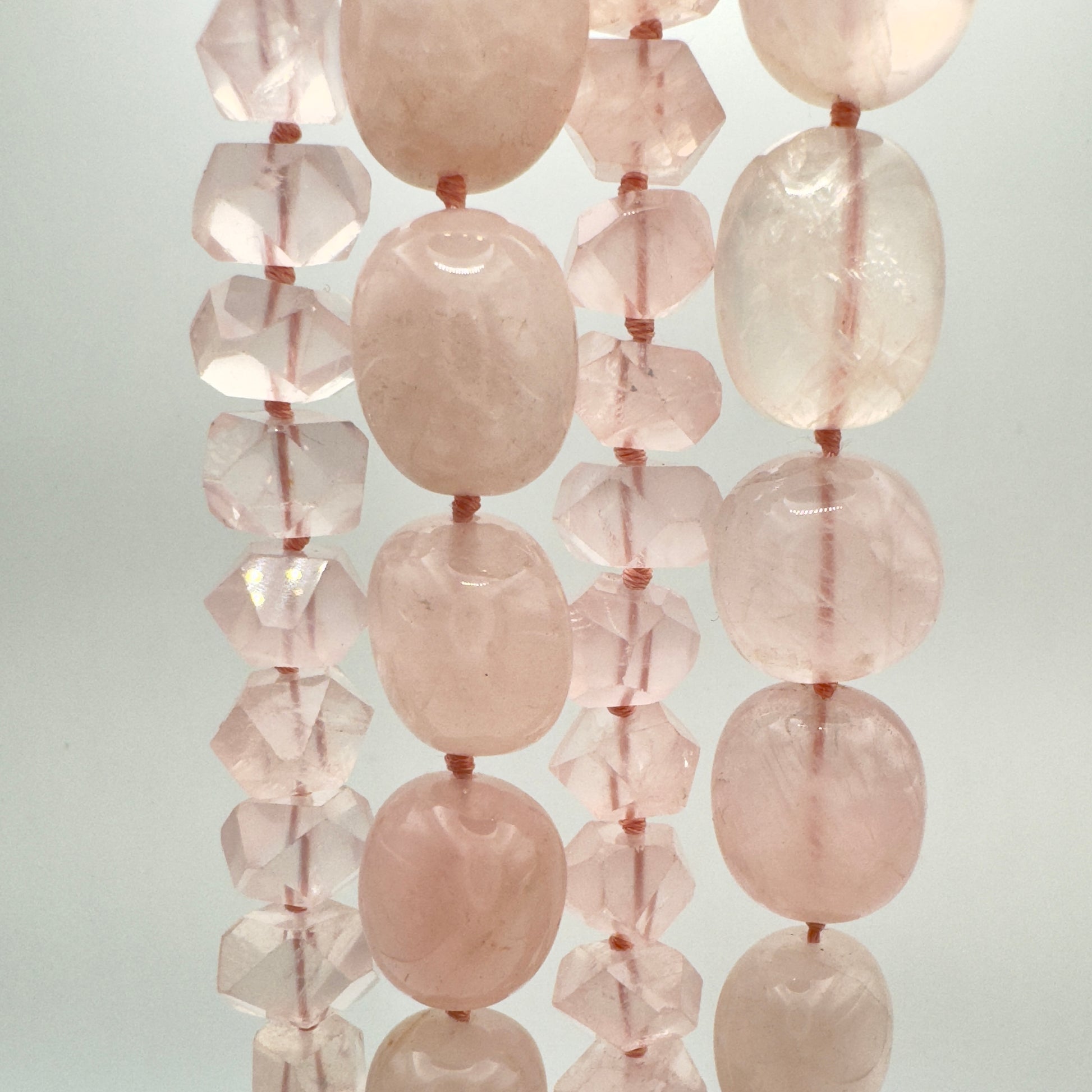 Necklace with pink and clear beads on a light gray background
