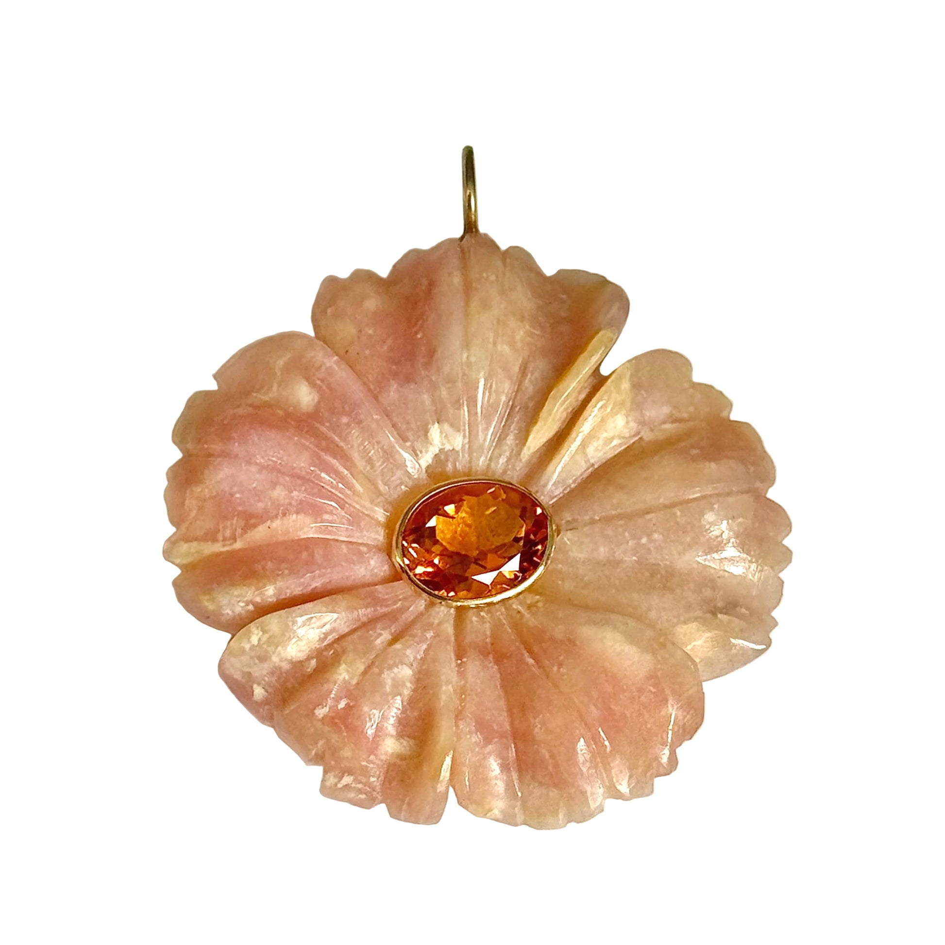 A carved floral pendant in pale pink stone with a central faceted amber-orange gemstone and a gold-toned setting, shown on a plain light background.