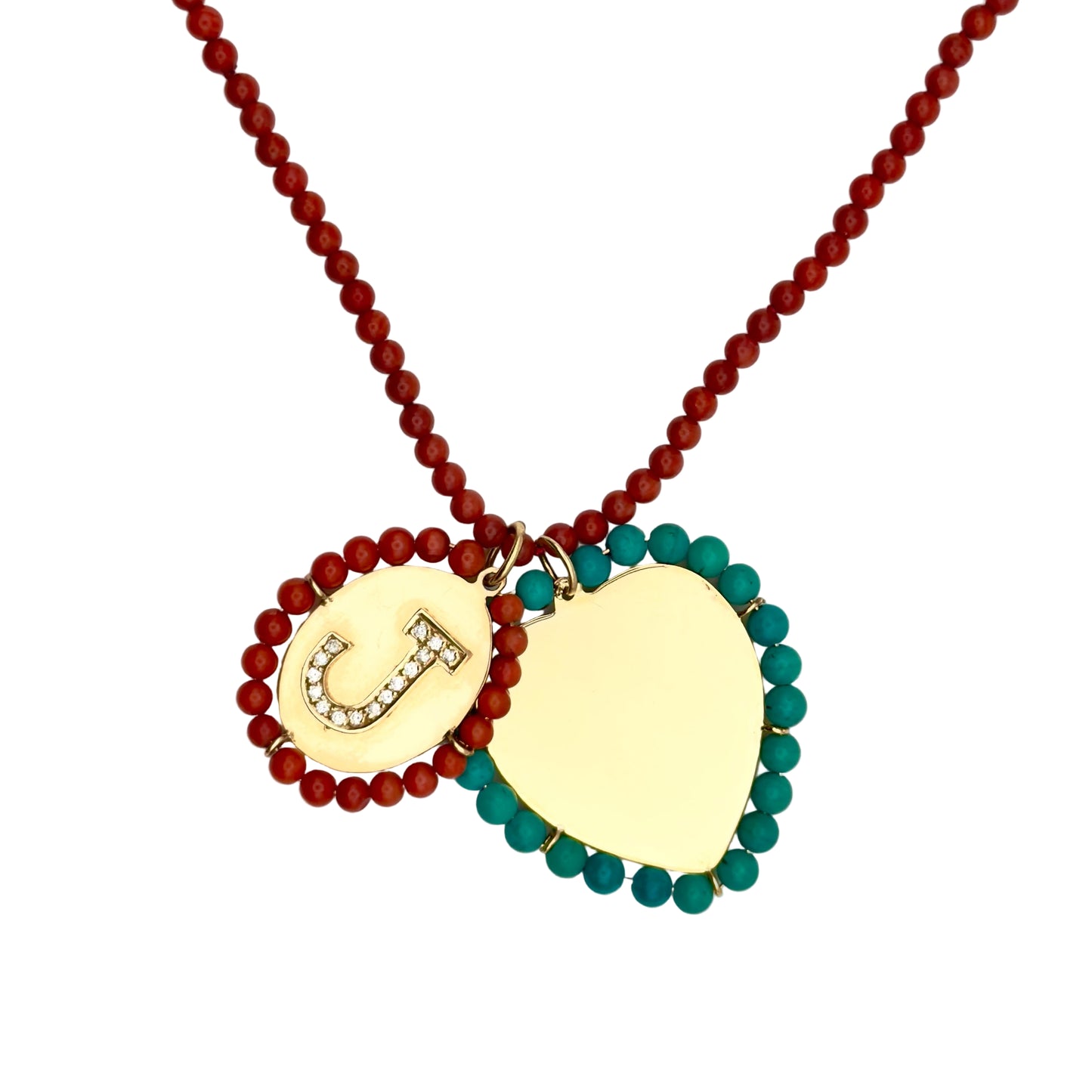 Necklace with gold pendant and red and green beads on a white background