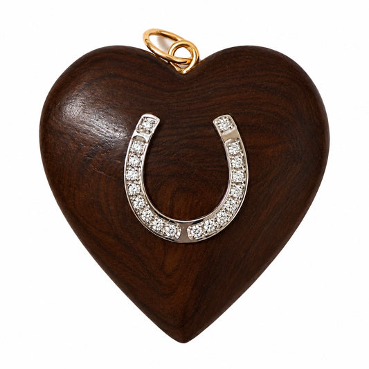 A heart-shaped wooden pendant with a polished dark brown wood grain finish, featuring a silver horseshoe-shaped embellishment paved with small clear diamonds and a gold-tone loop at the top, shown on a plain white background.