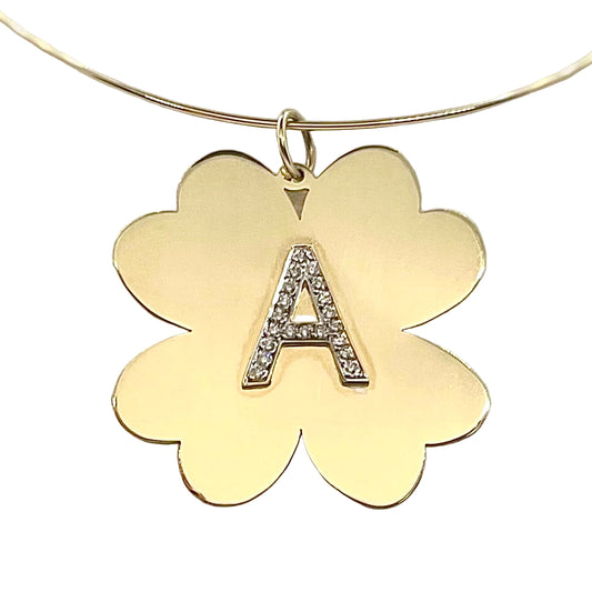 Gold clover-shaped pendant with letter 'A' on a light gray background