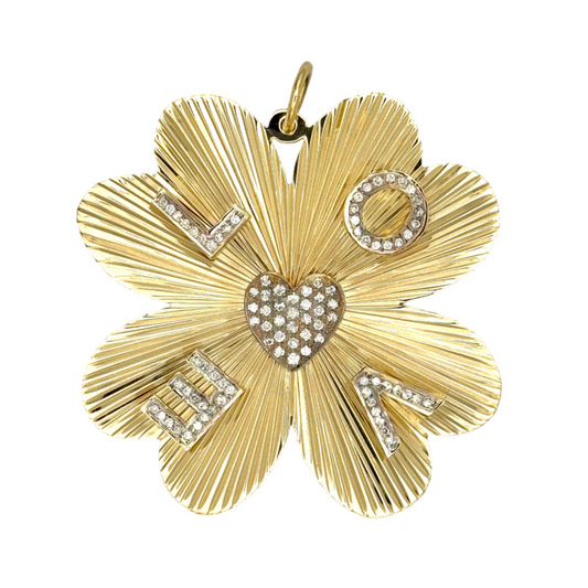 Clover pendant with floral design and embedded stones on a light background