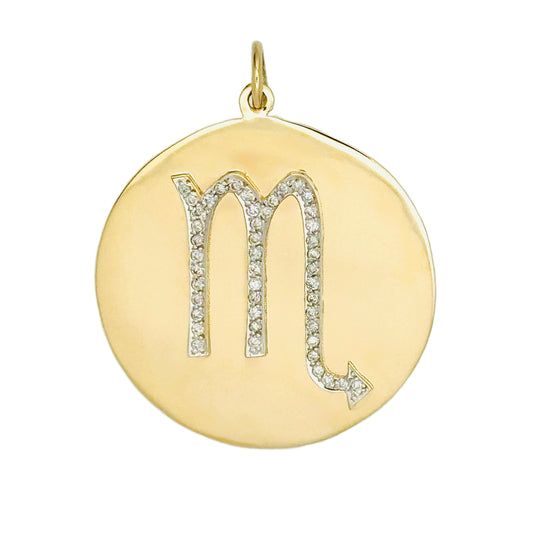 Gold pendant with a zodiac symbol on a white background