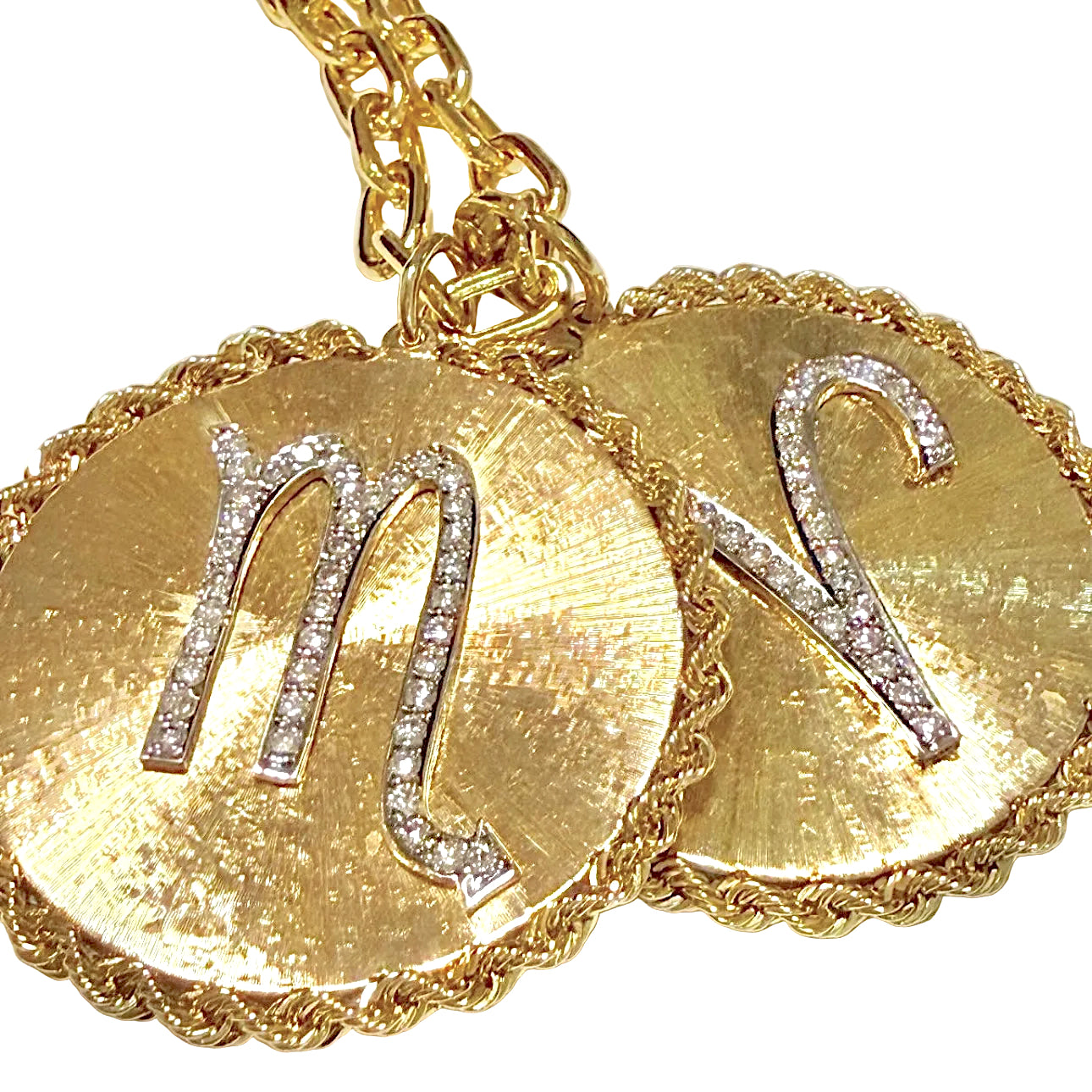 Gold necklace with Scorpio and Aries pendants on a white background