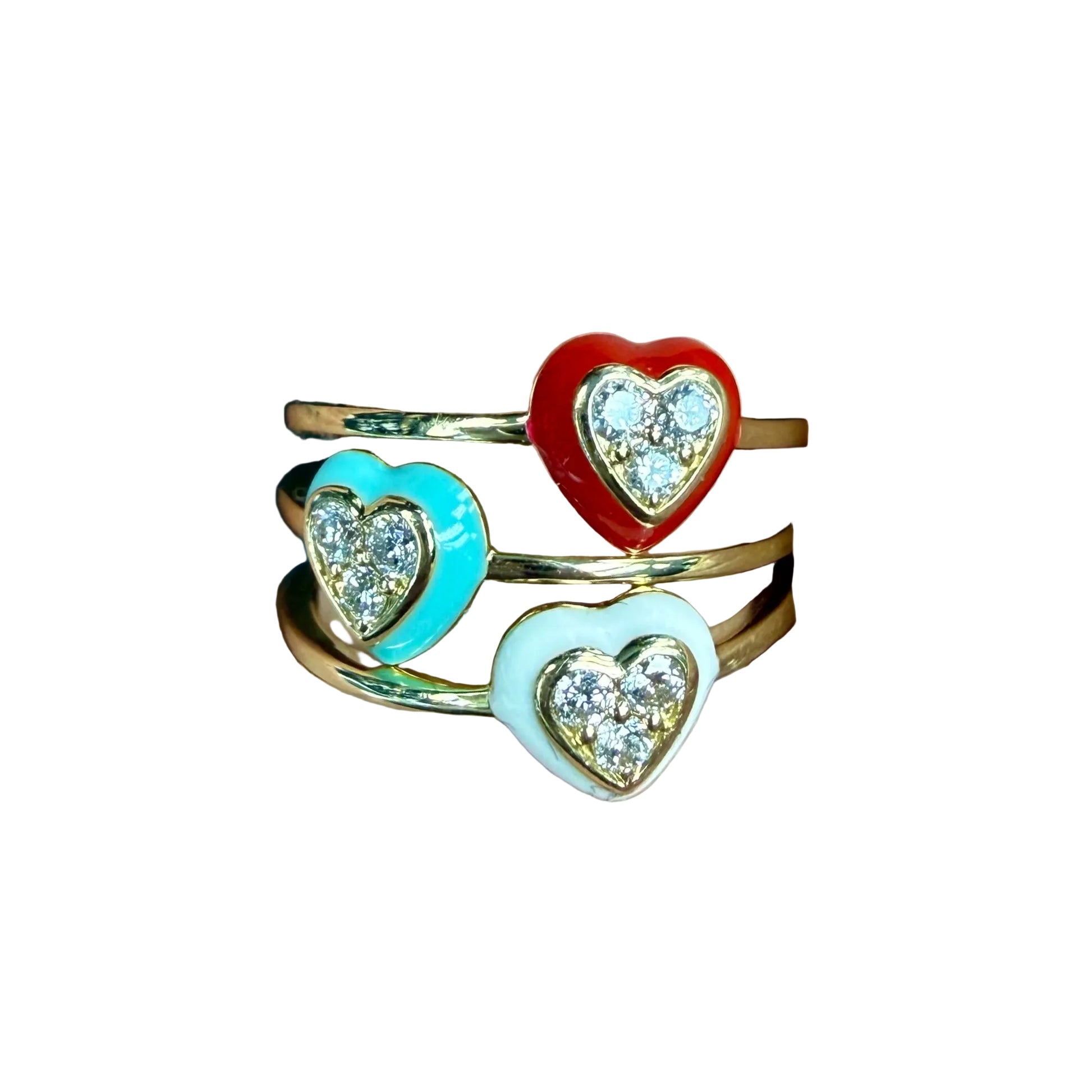 Three heart-shaped rings with colored stones on a finger
