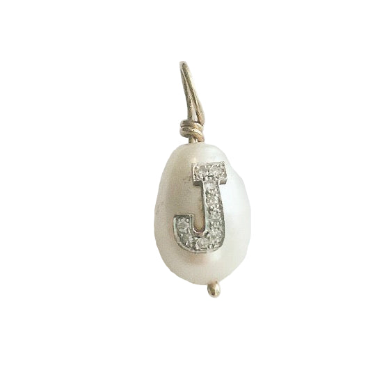 A tear drop pearl with a pave diamond initial attached to a small chain.