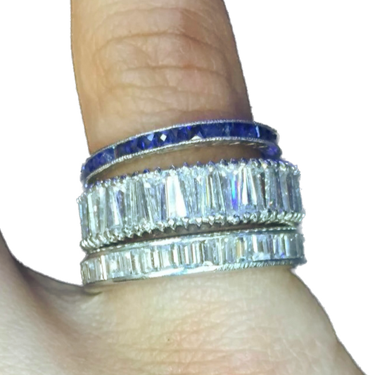 Hand shown three rings made of gemstones. 